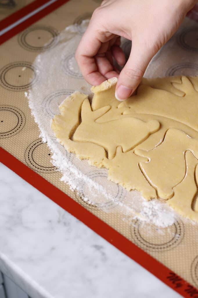 peeling away dough from a bunny sugar cookie