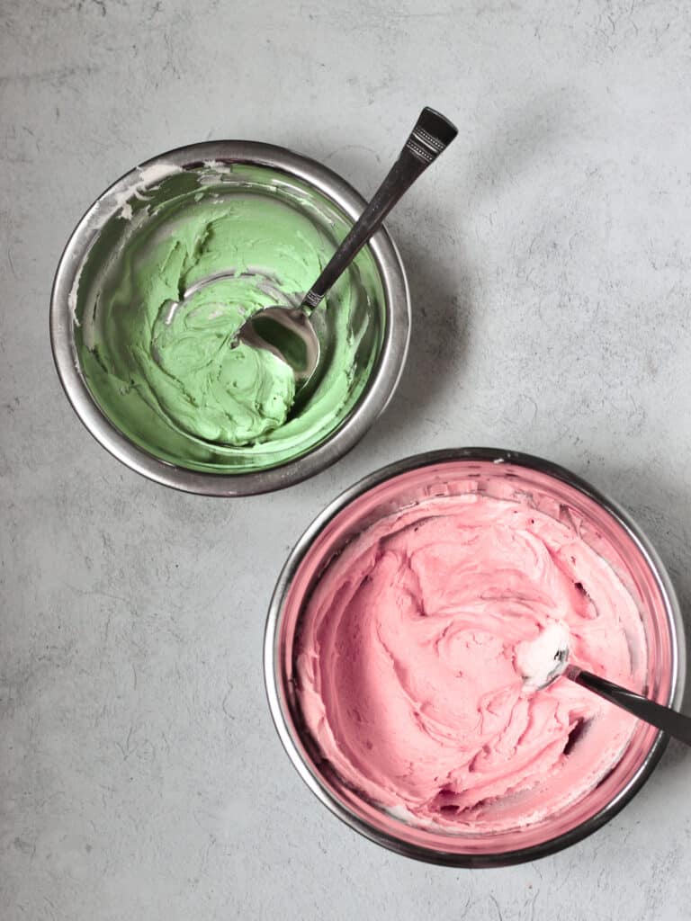 bowls of pink and green frosting