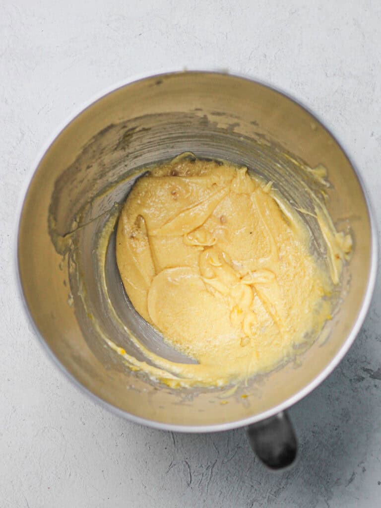 Mixing bowl full of light colored cookie dough.