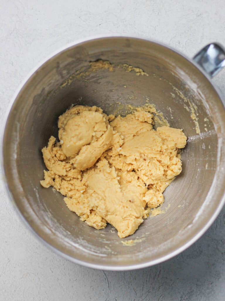 Mixing bowl full of light colored cookie dough