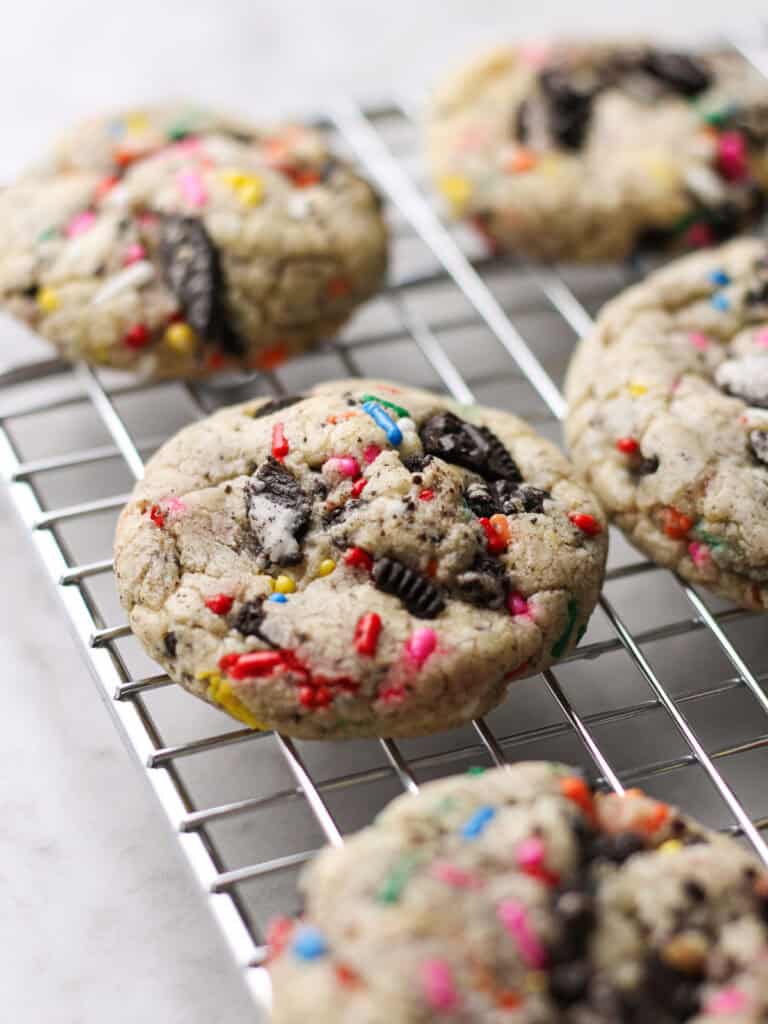Baked Oreo funfetti cookies, sitting on a cooling rack.