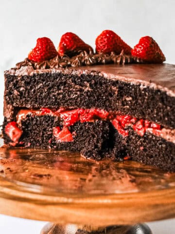Inside look at chocolate layer cake with strawberry filling.