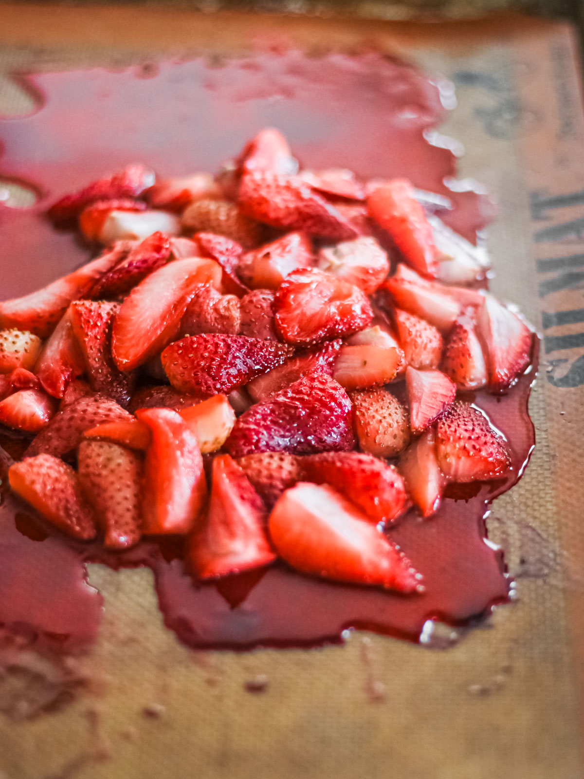 Roasted strawberries on a baking sheet.