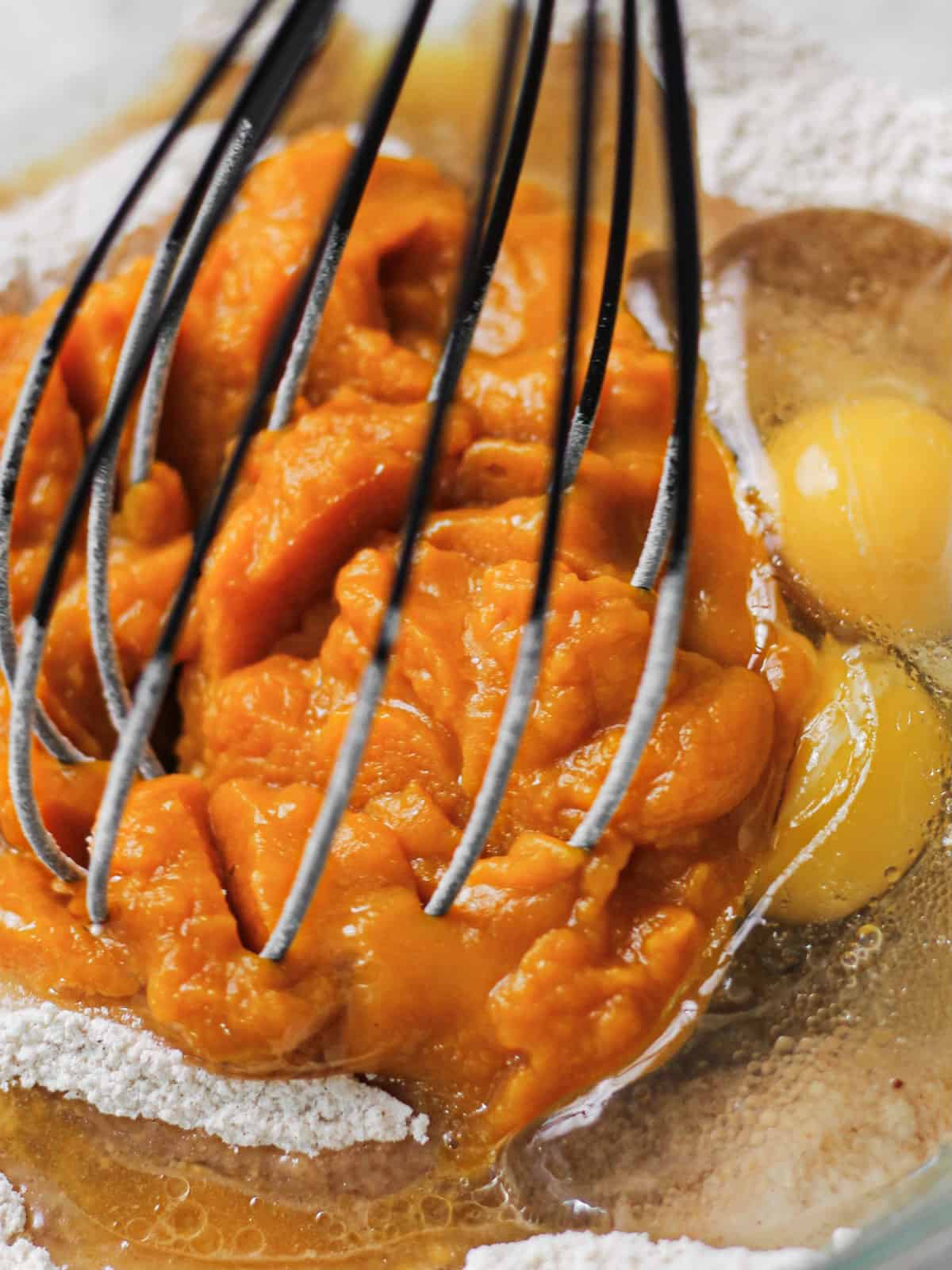 Mixing pumpkin into batter for mini muffins.