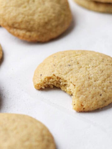 Brown butter sugar cookie with a bite missing from it.