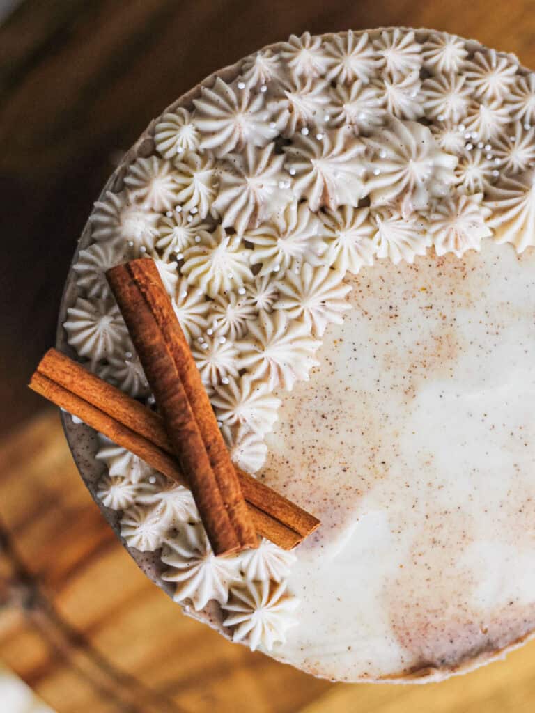 Overhead shot of a dirty chai cake, decorated with chai spice buttercream and cinnamon sticks.