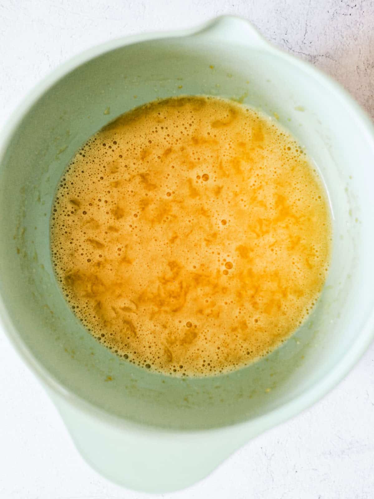 Oil, sugar, eggs, and pineapple mixed together for carrot cake.
