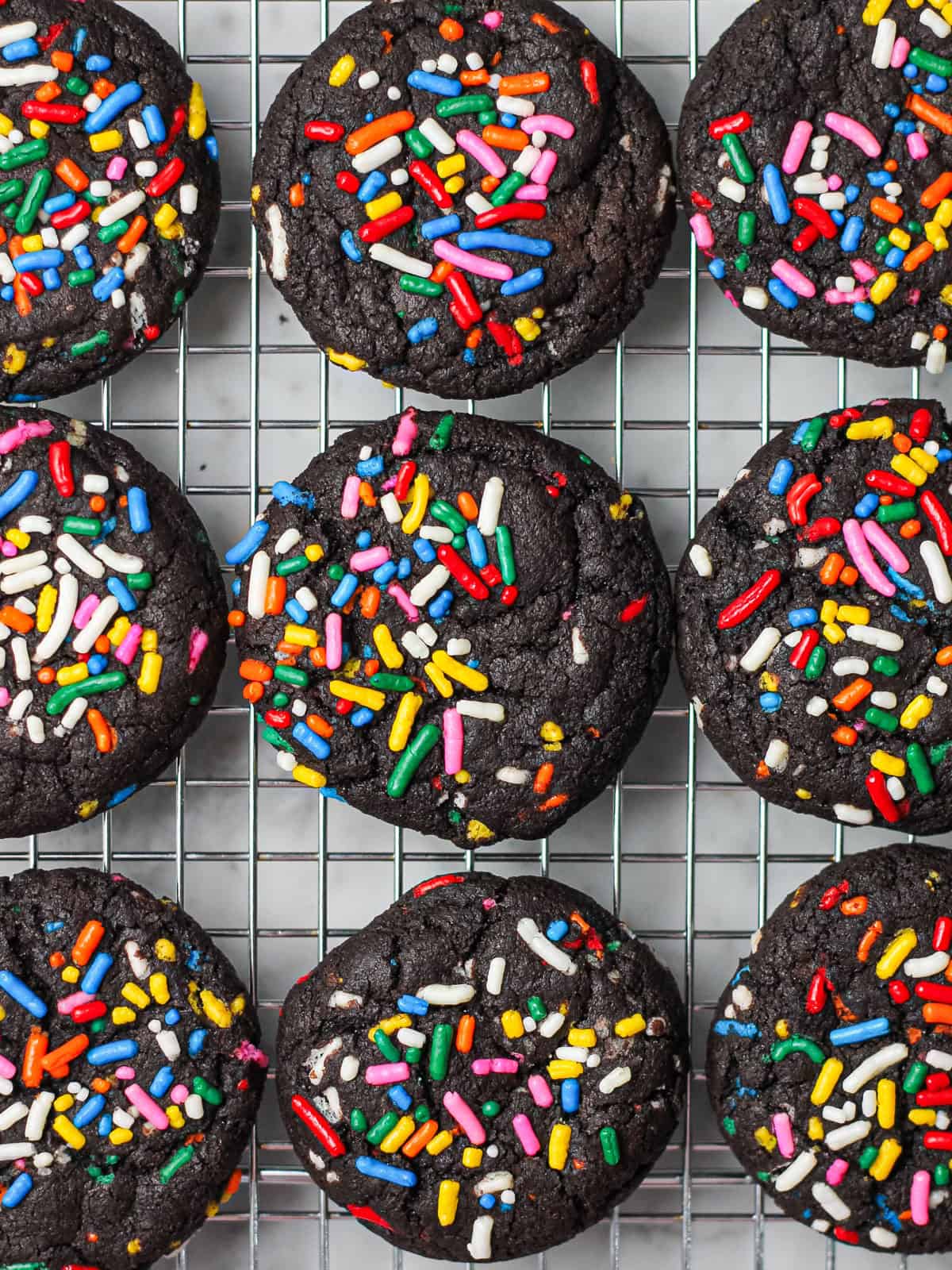 Baked chocolate sprinkle cookies, topped with lots of rainbow sprinkles!