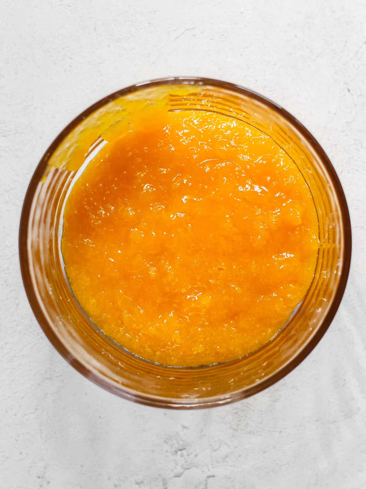 Overhead image of mango filling in glass bowl.