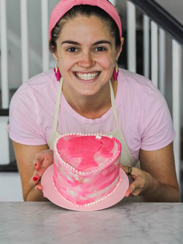 Image of Susan, holding a pink Barbie cake.