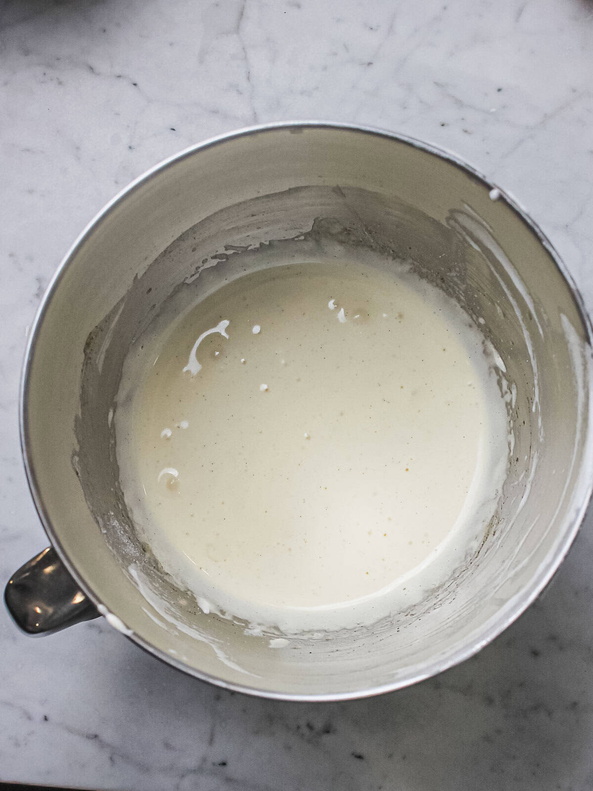 Egg yolks whipped pale with sugar and vanilla until thick and creamy.