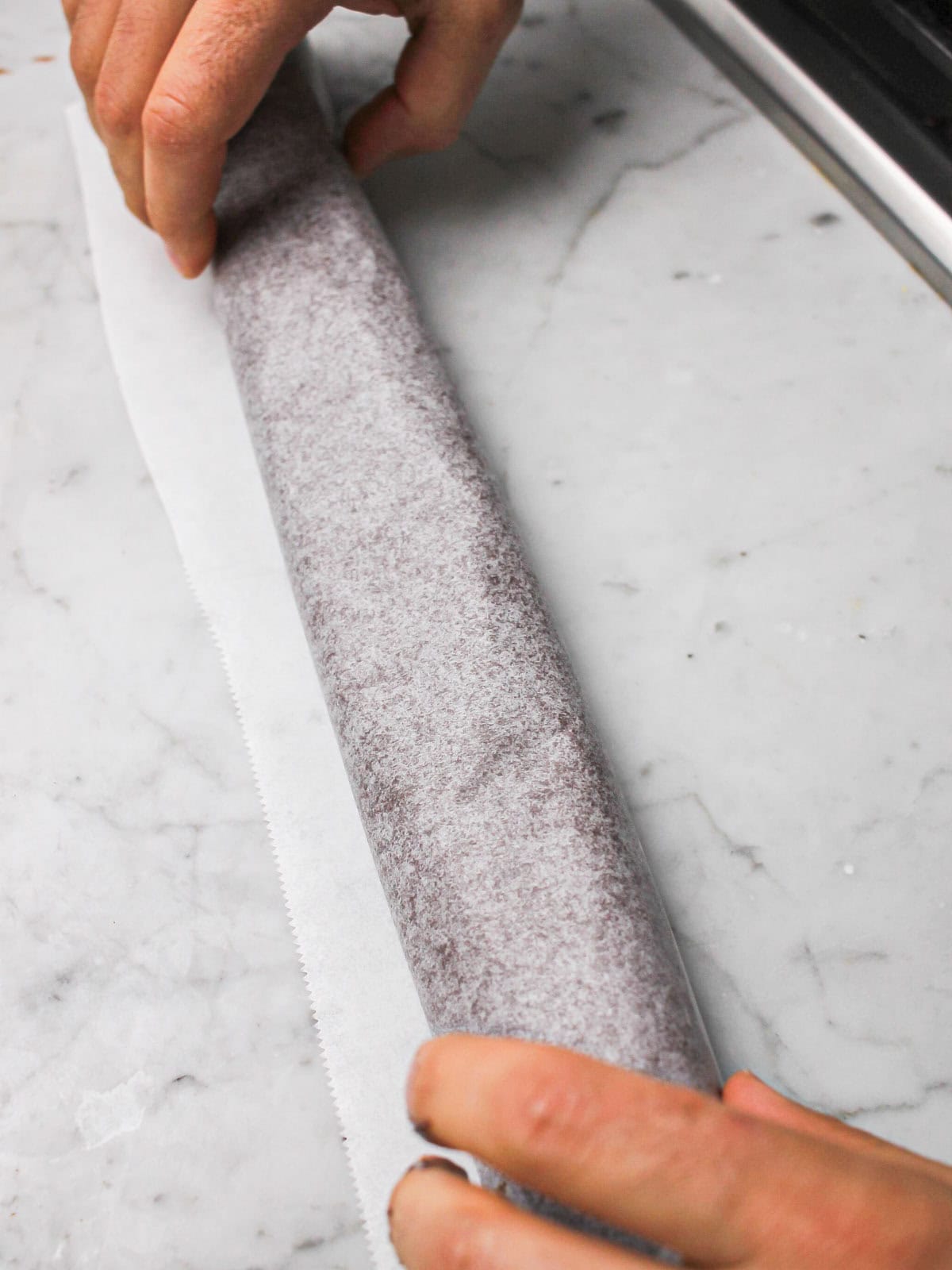 Tempered chocolate rolled into parchment paper to set.