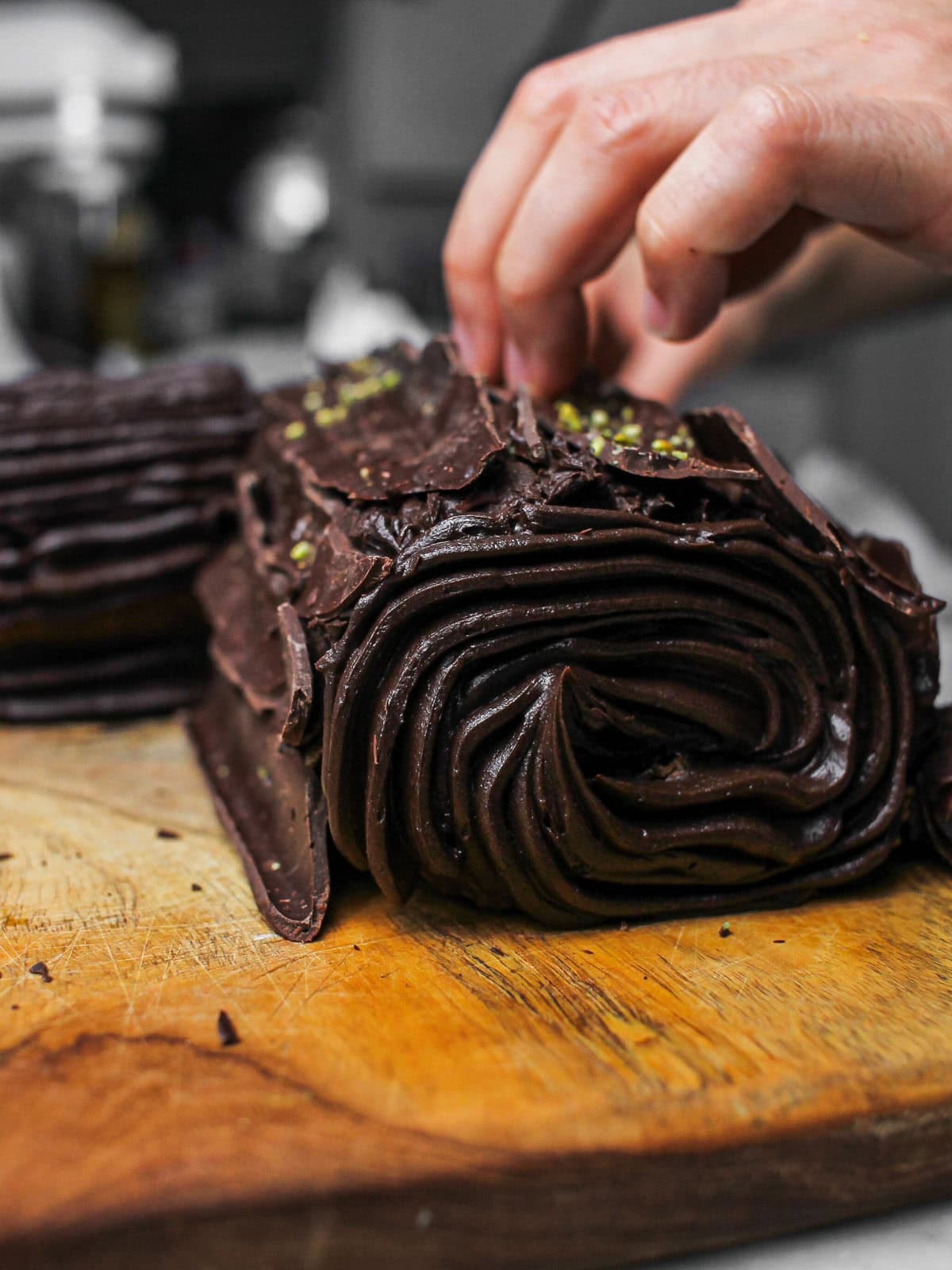 Action shot of Saman decorating our chocolate yule log.