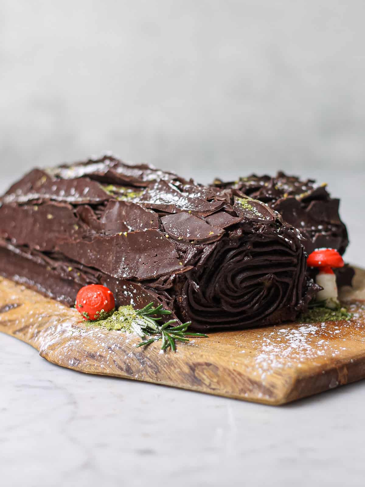 Our finished chocolate yule log, resting on a wooden cutting board.