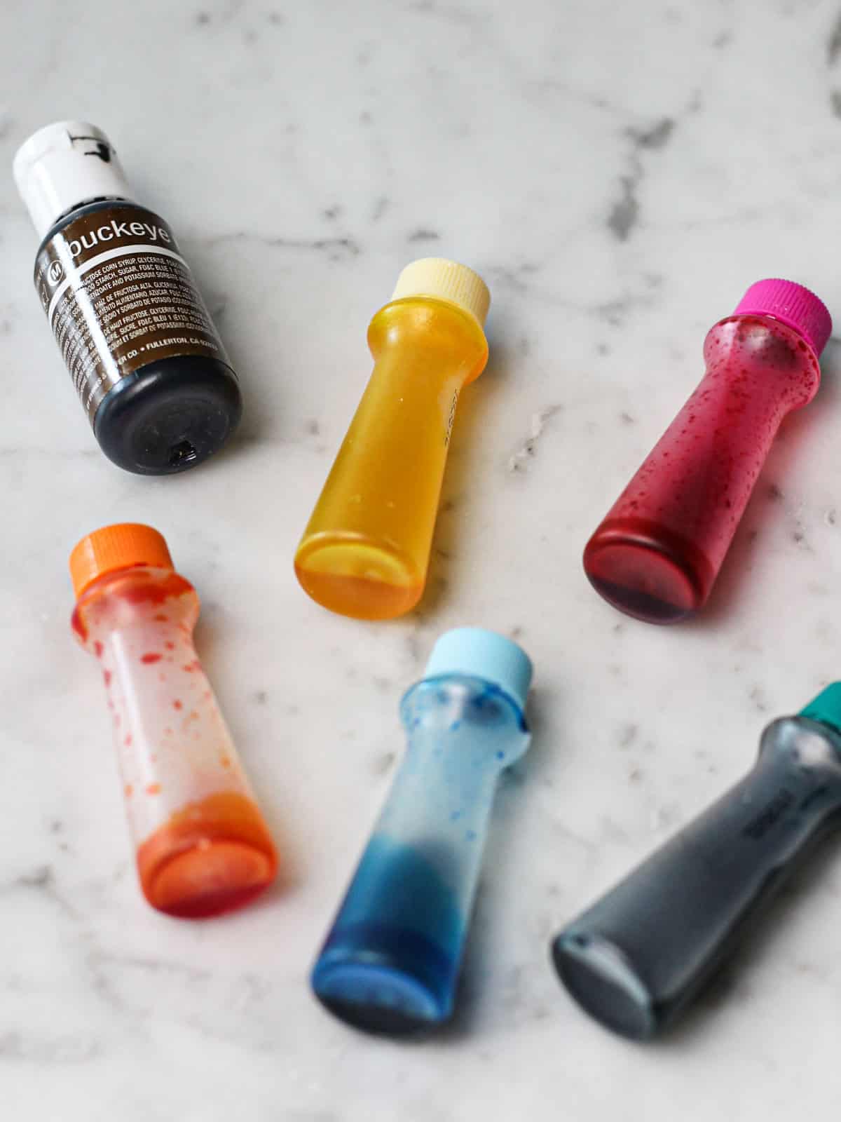 Up-close shot of bottles of food gel for dying frosting. 