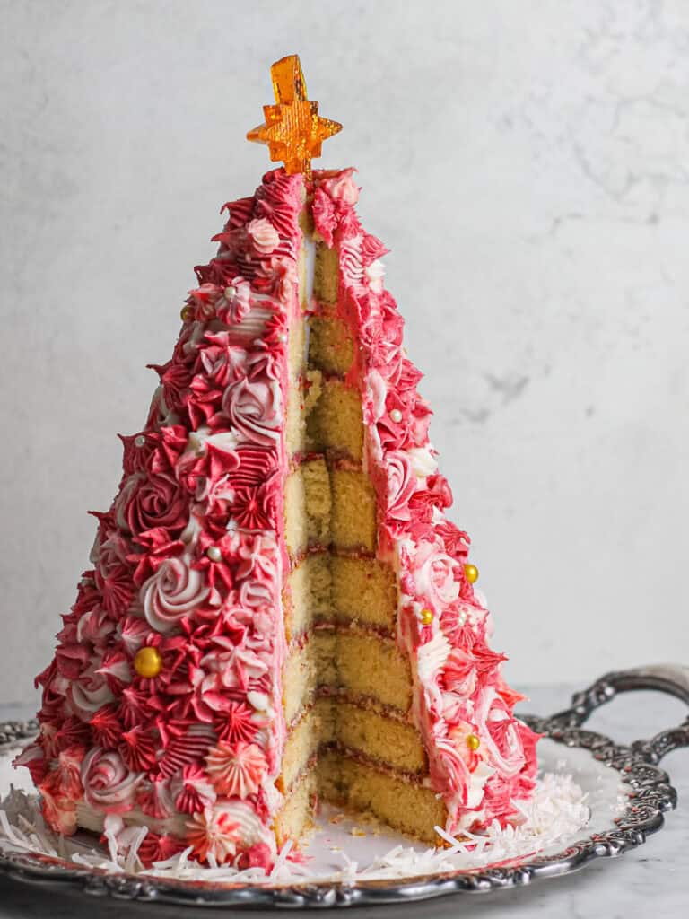 Pink 3D Christmas Tree Cake, cut open to reveal the many layers inside.