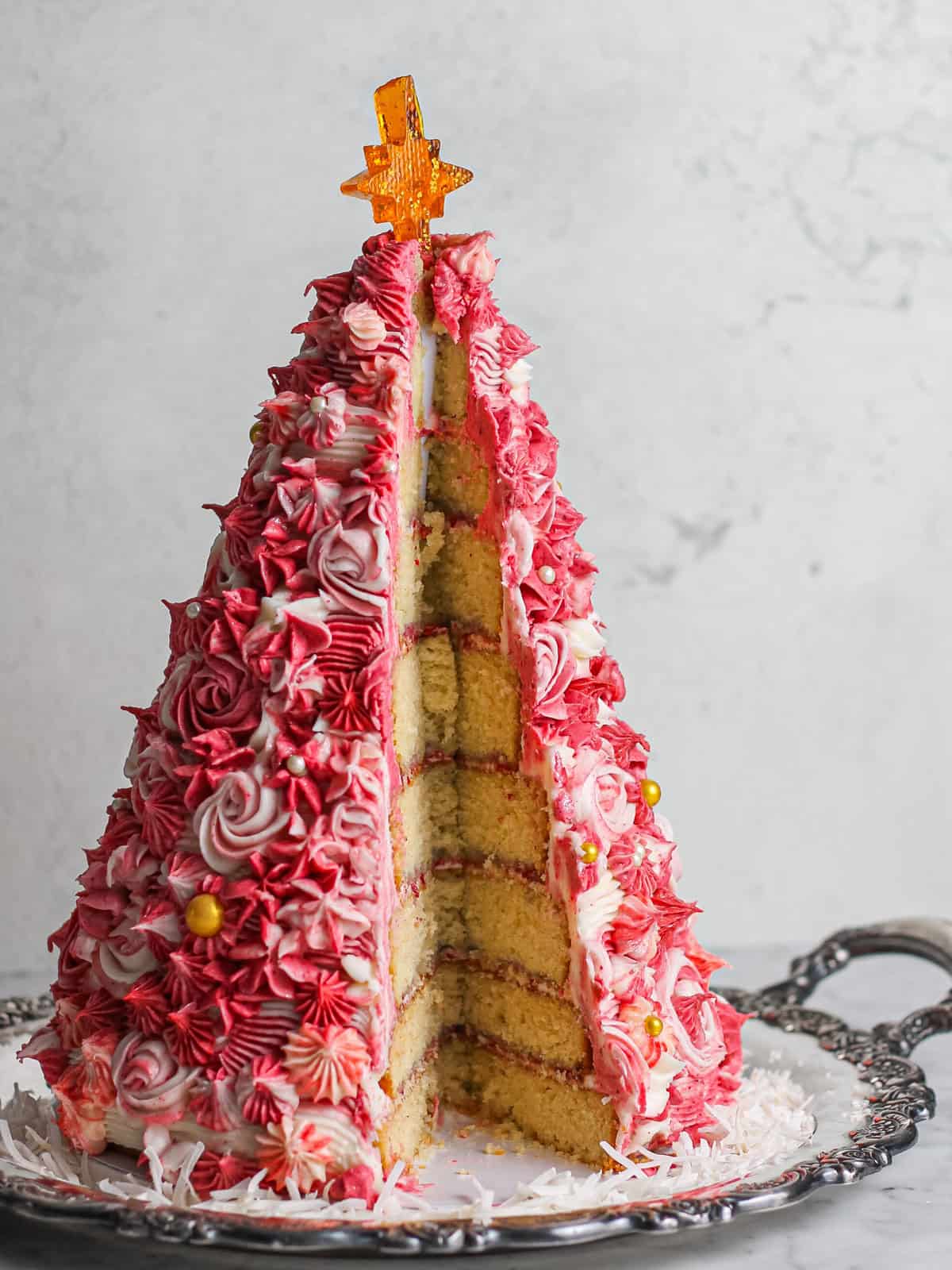 Pink 3D Christmas Tree Cake, cut open to reveal the many layers inside.