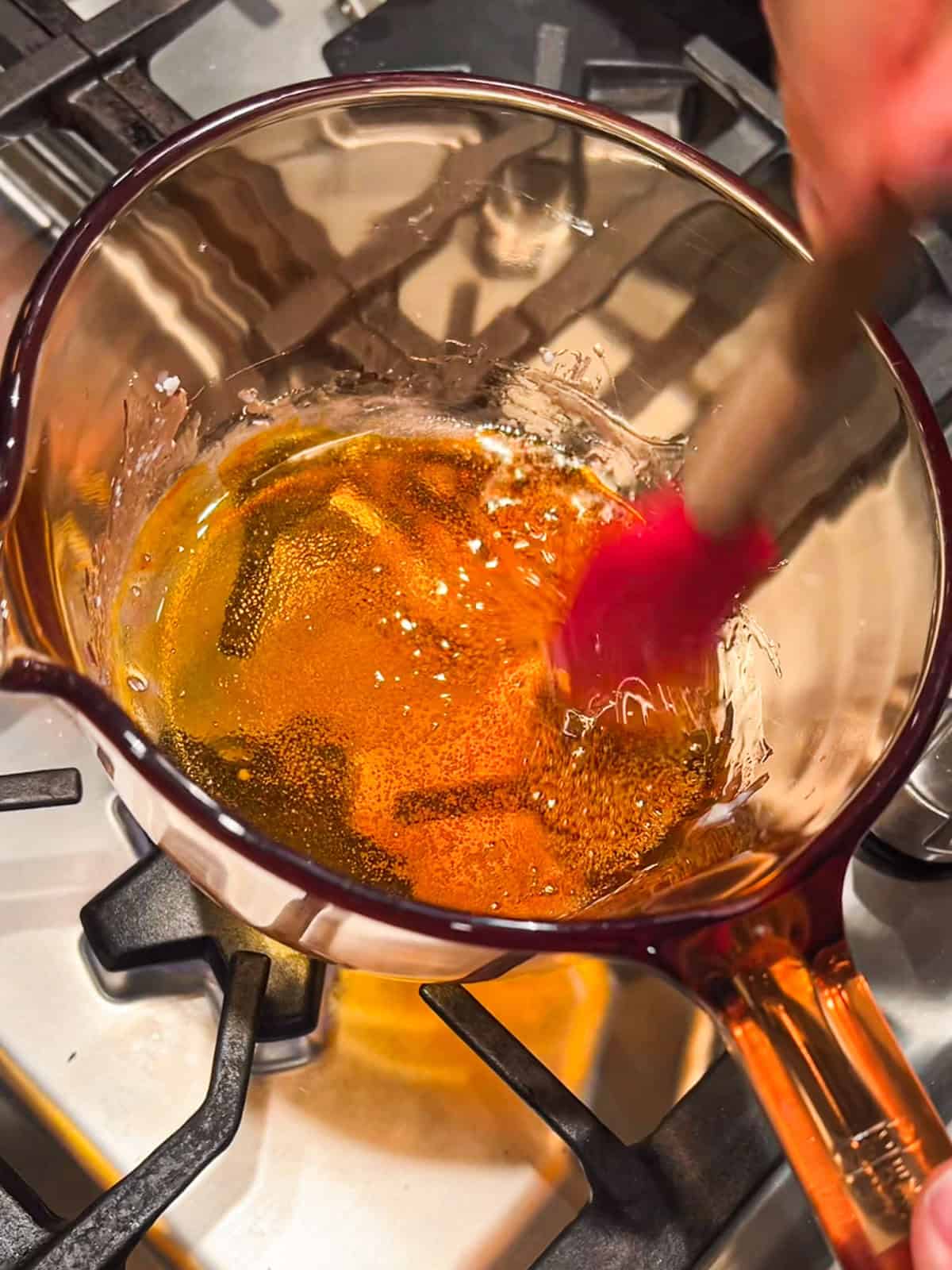 Cooking gold isomalt over the stovetop.