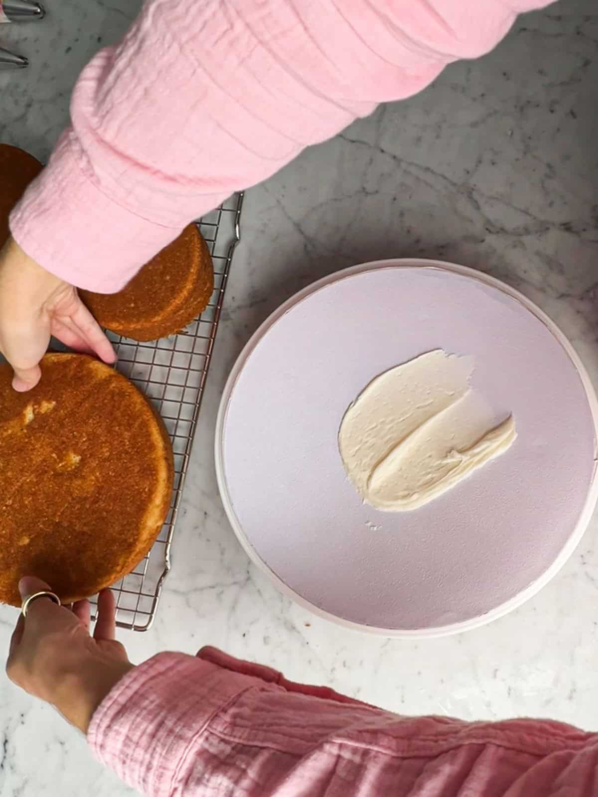 Cake board with buttercream to hold a tree cake in place.