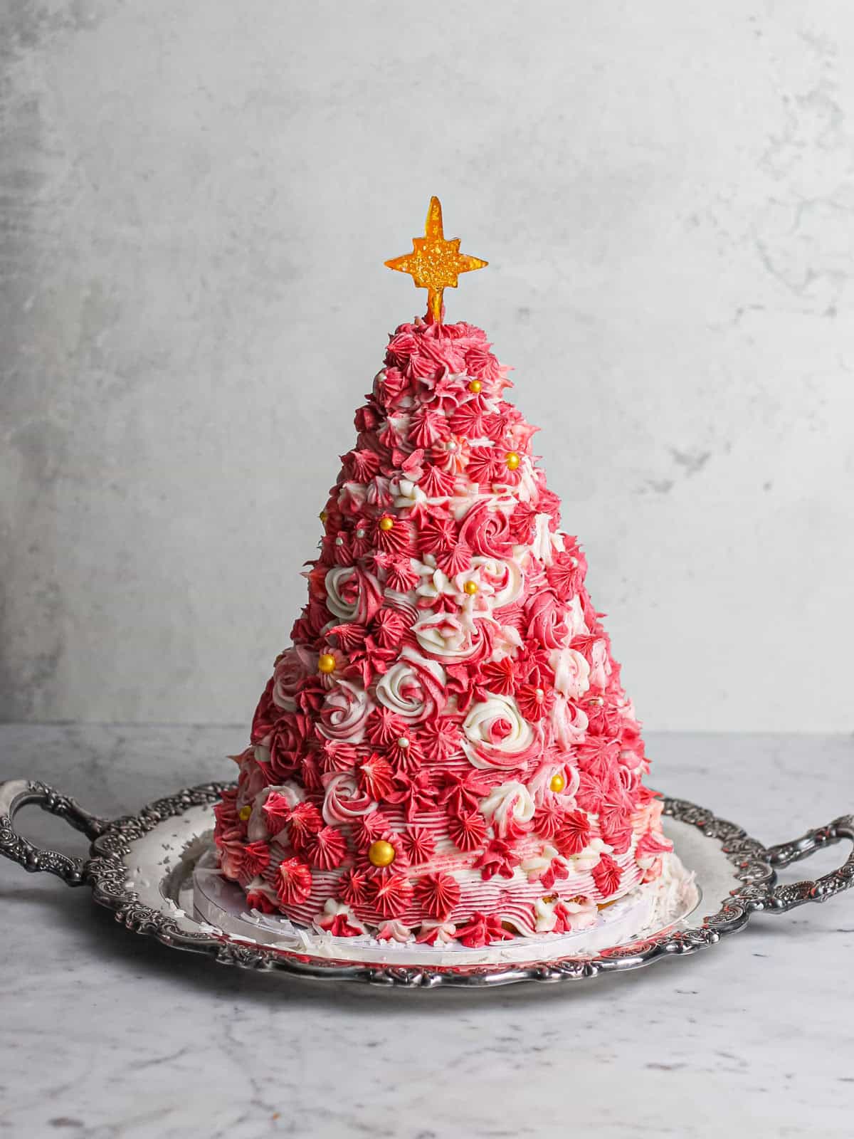 Pink 3D Christmas Tree Cake, sitting on a silver platter.