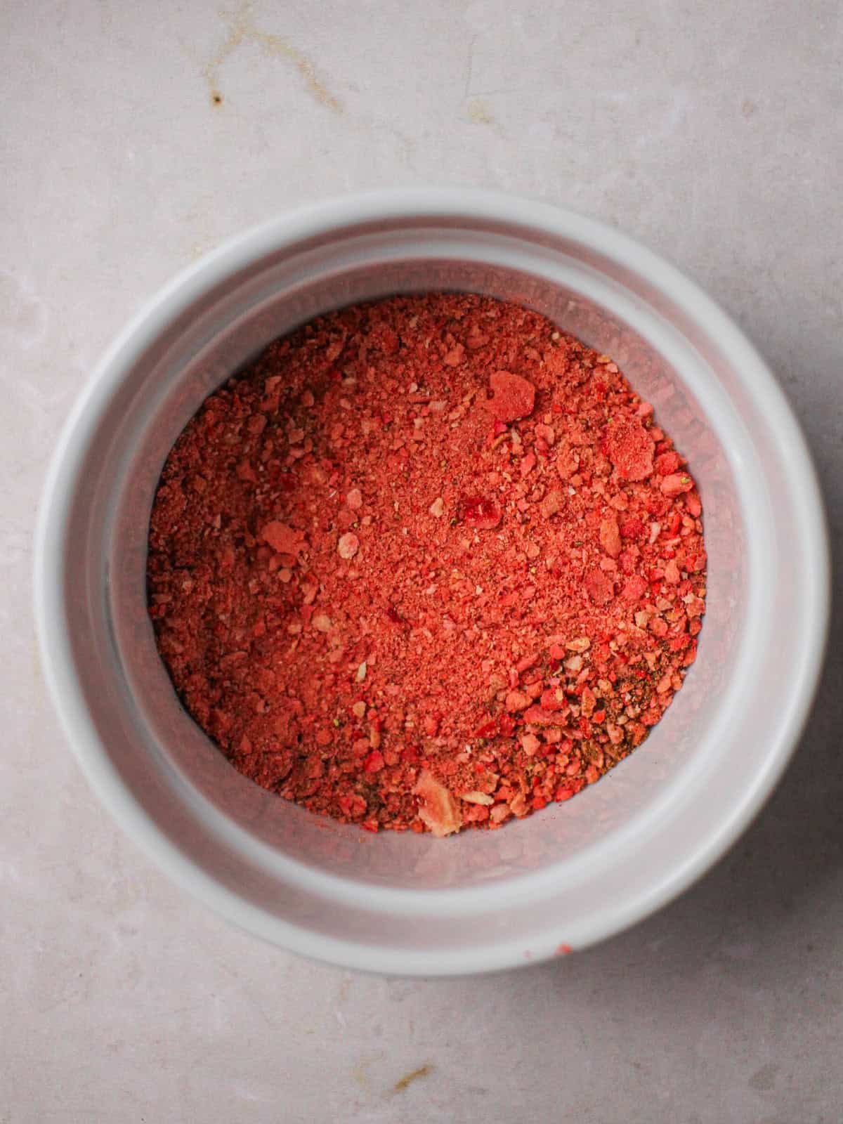Freeze-dried strawberry powder in a white ramekin.