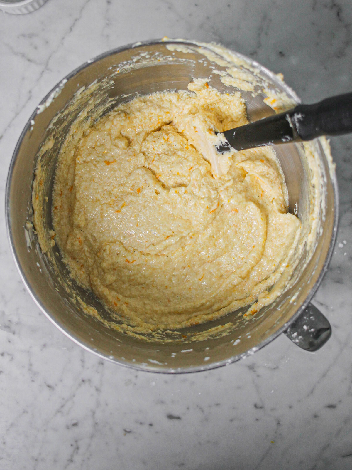 Orange zest added to mixing bowl.