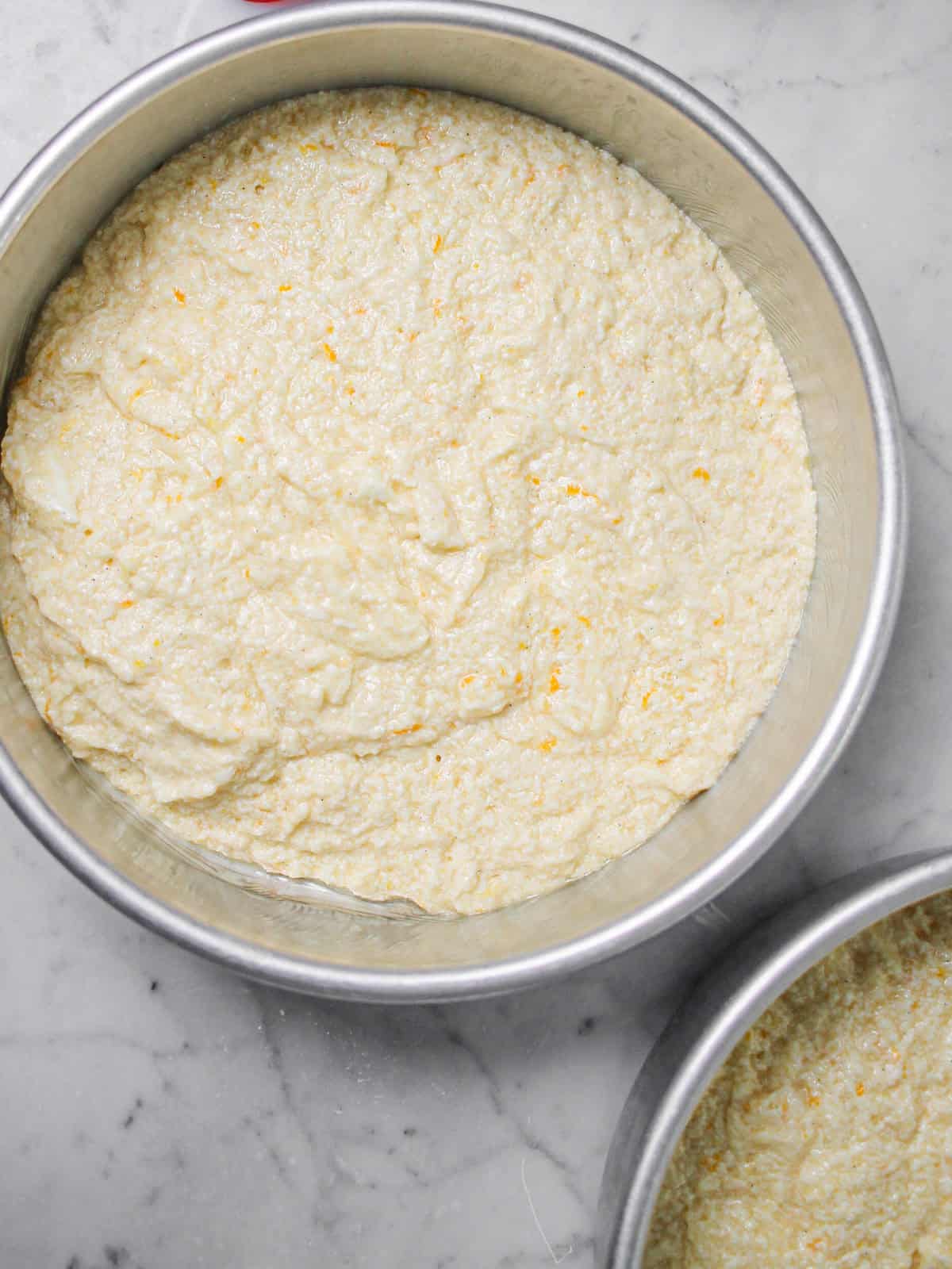 Cake pans filled with batter.
