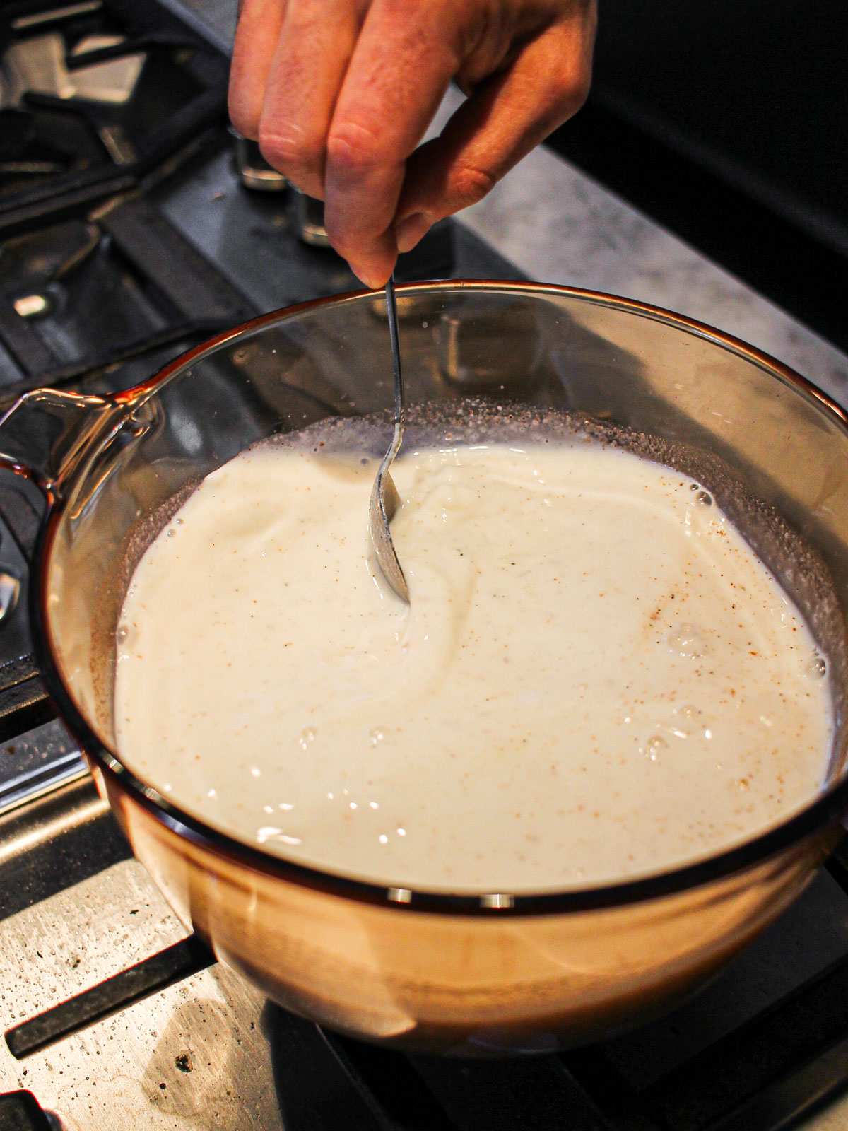 Stirring ingredients over stove for phirni.
