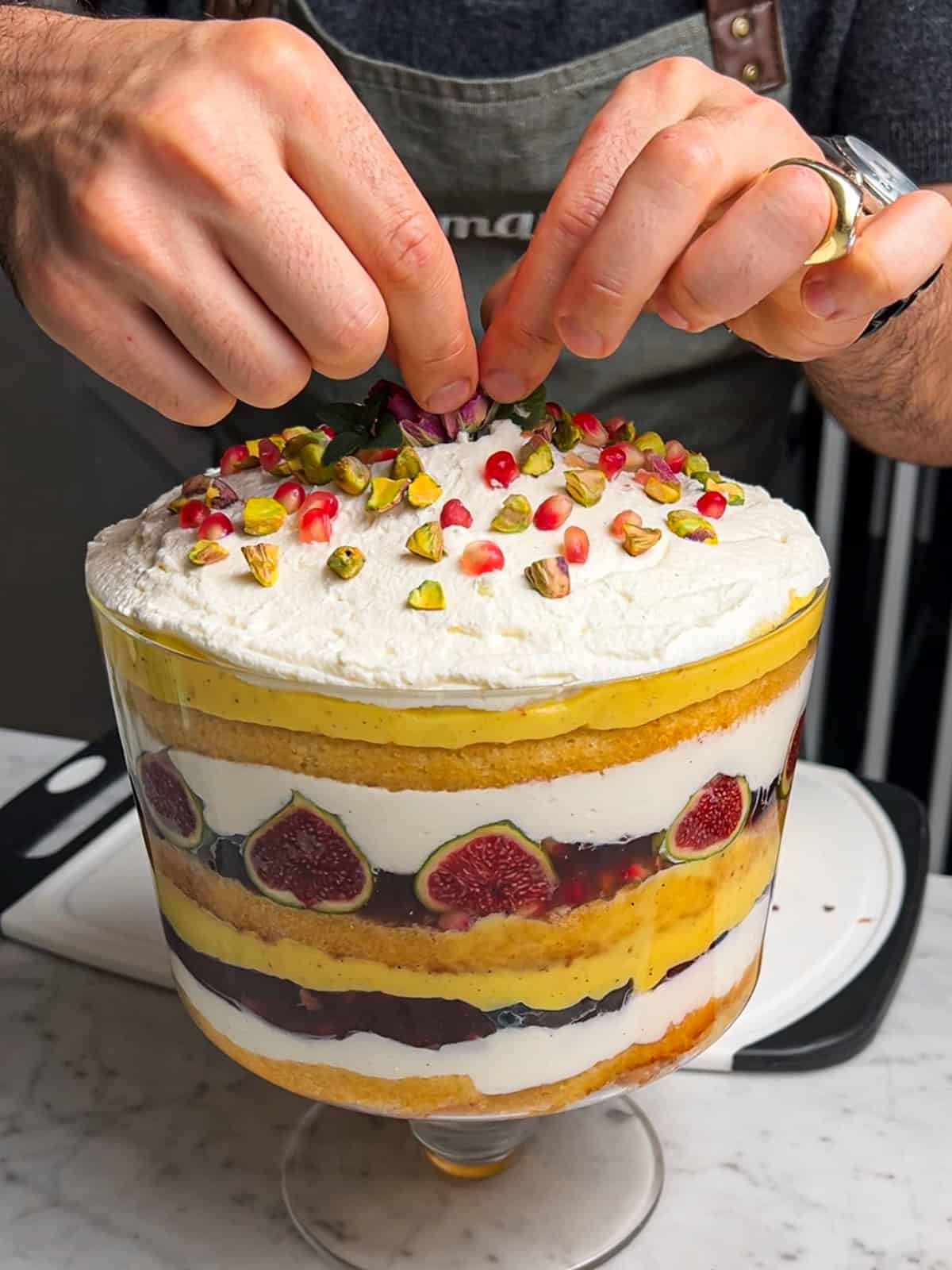 Adding decorations to finished saffron orange trifle.