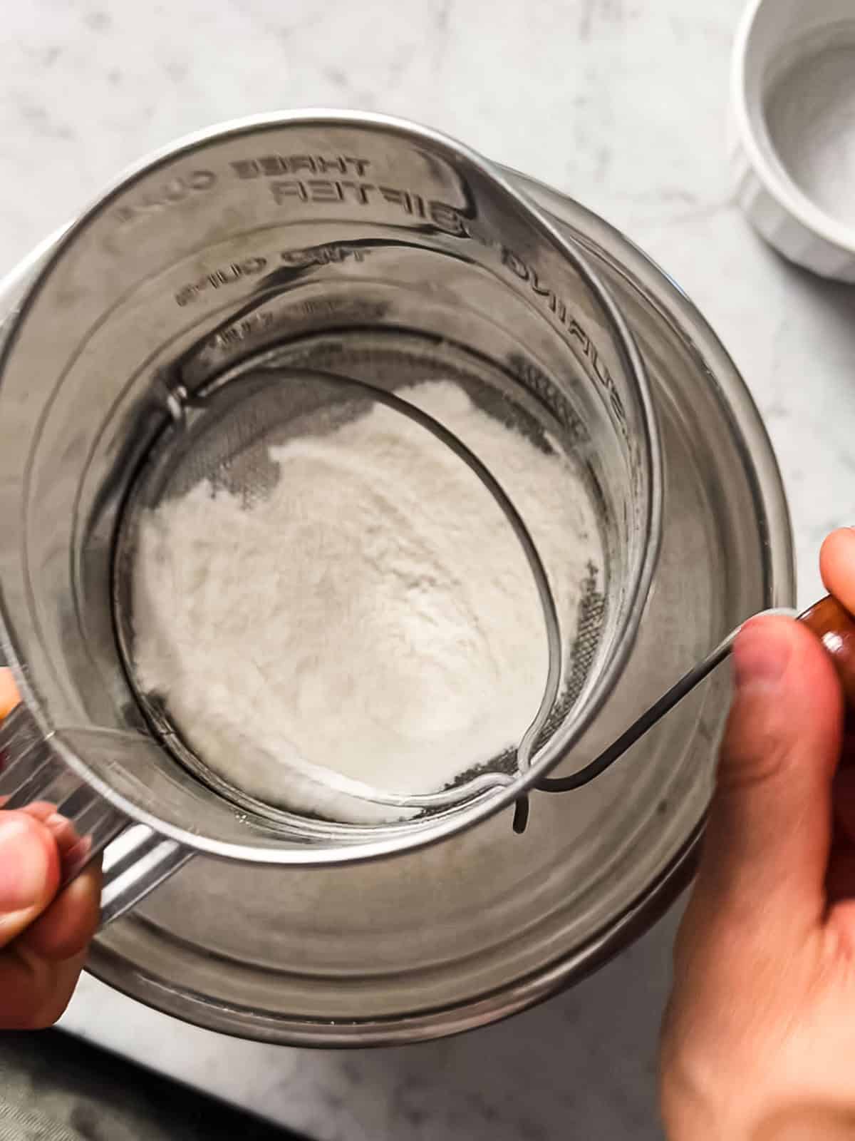 Sifting rice flour for saffron phirni.