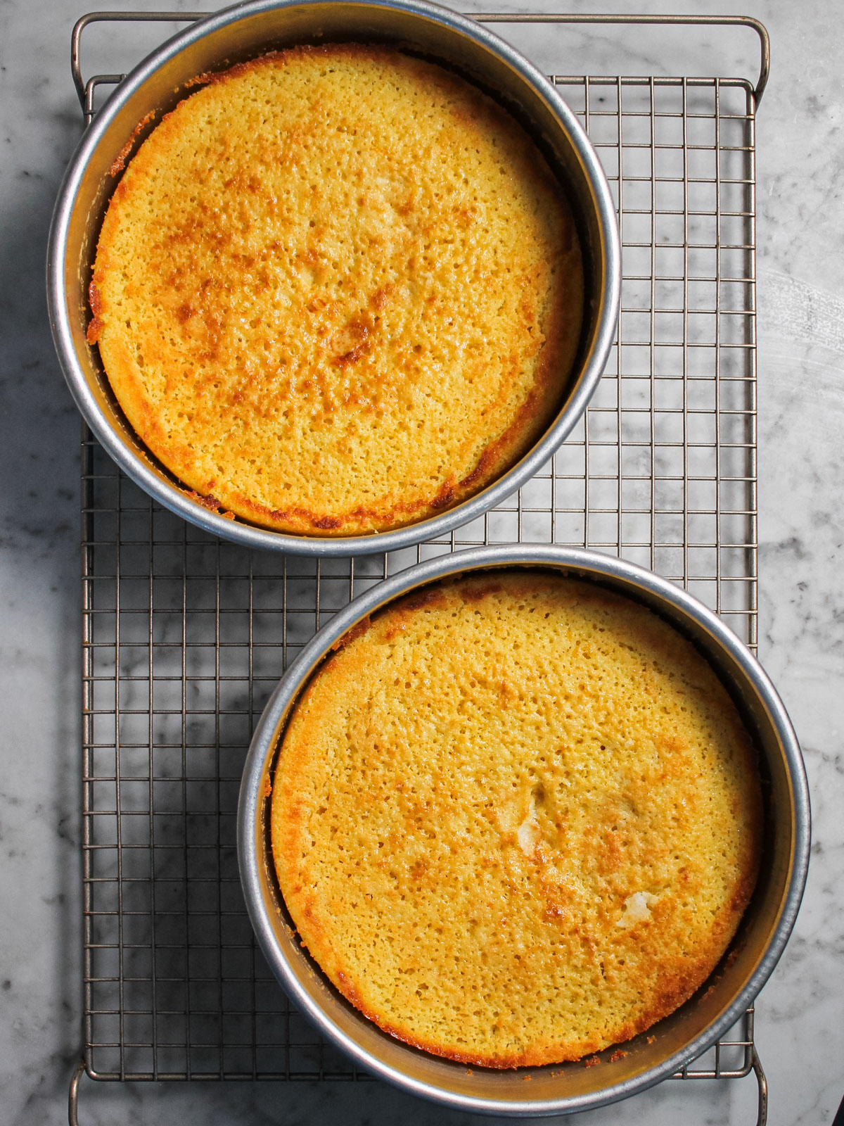 Baked cake layers on cooling rack.