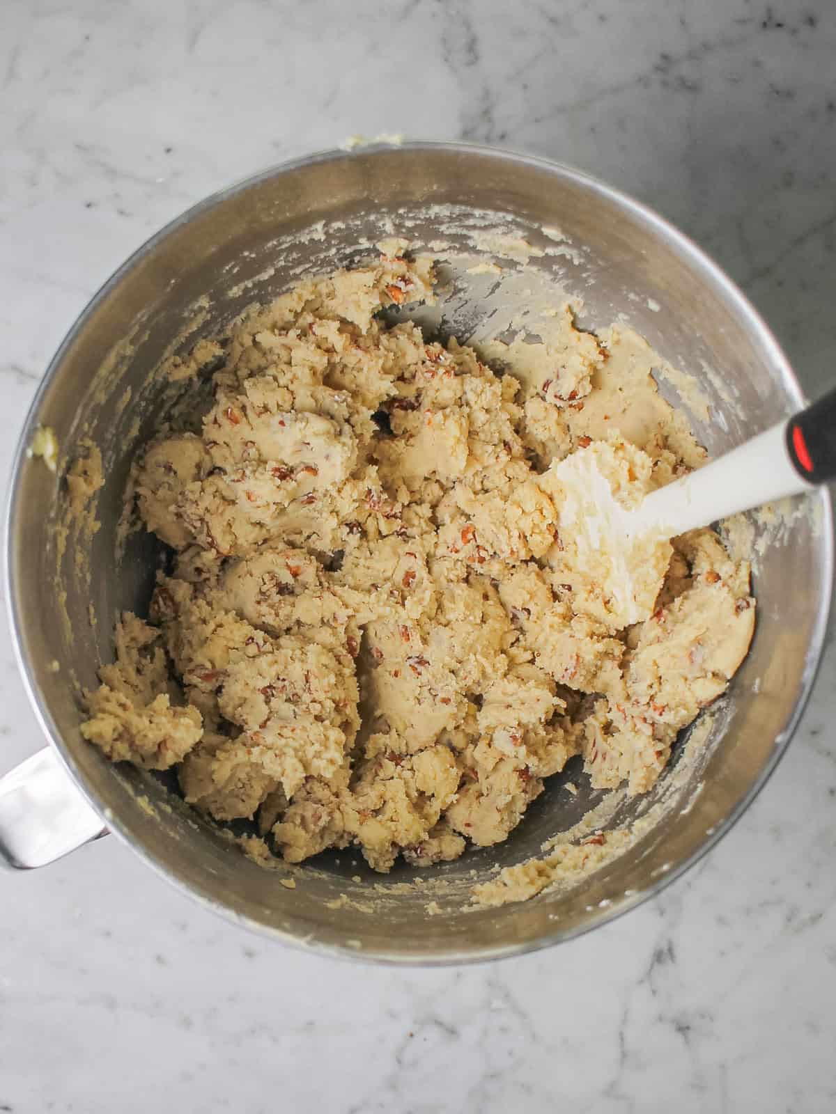 Mixing bowl filled with dough for snowball cookies.