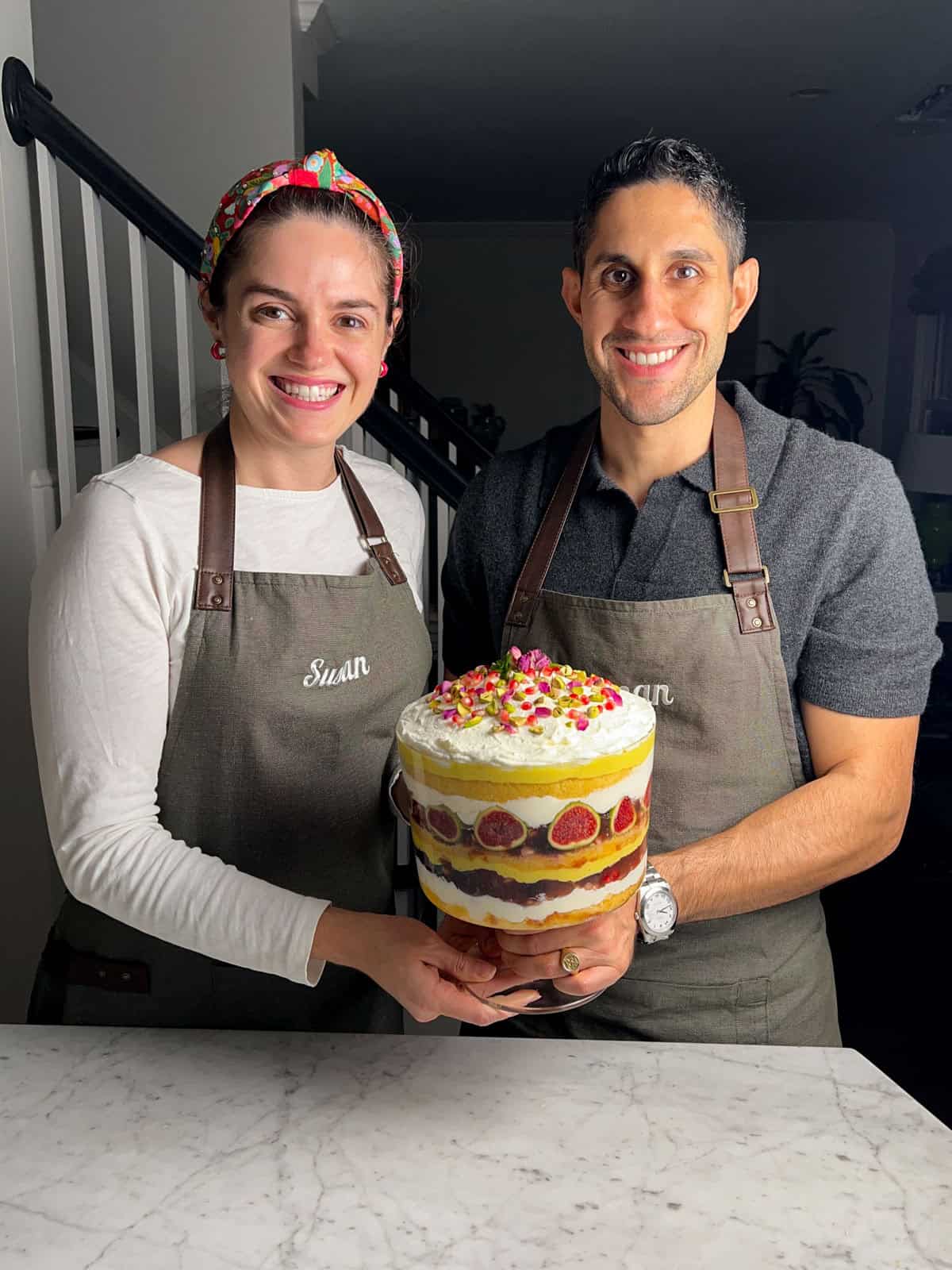 Saman and Susan holding their winning saffron orange trifle with cardamom.