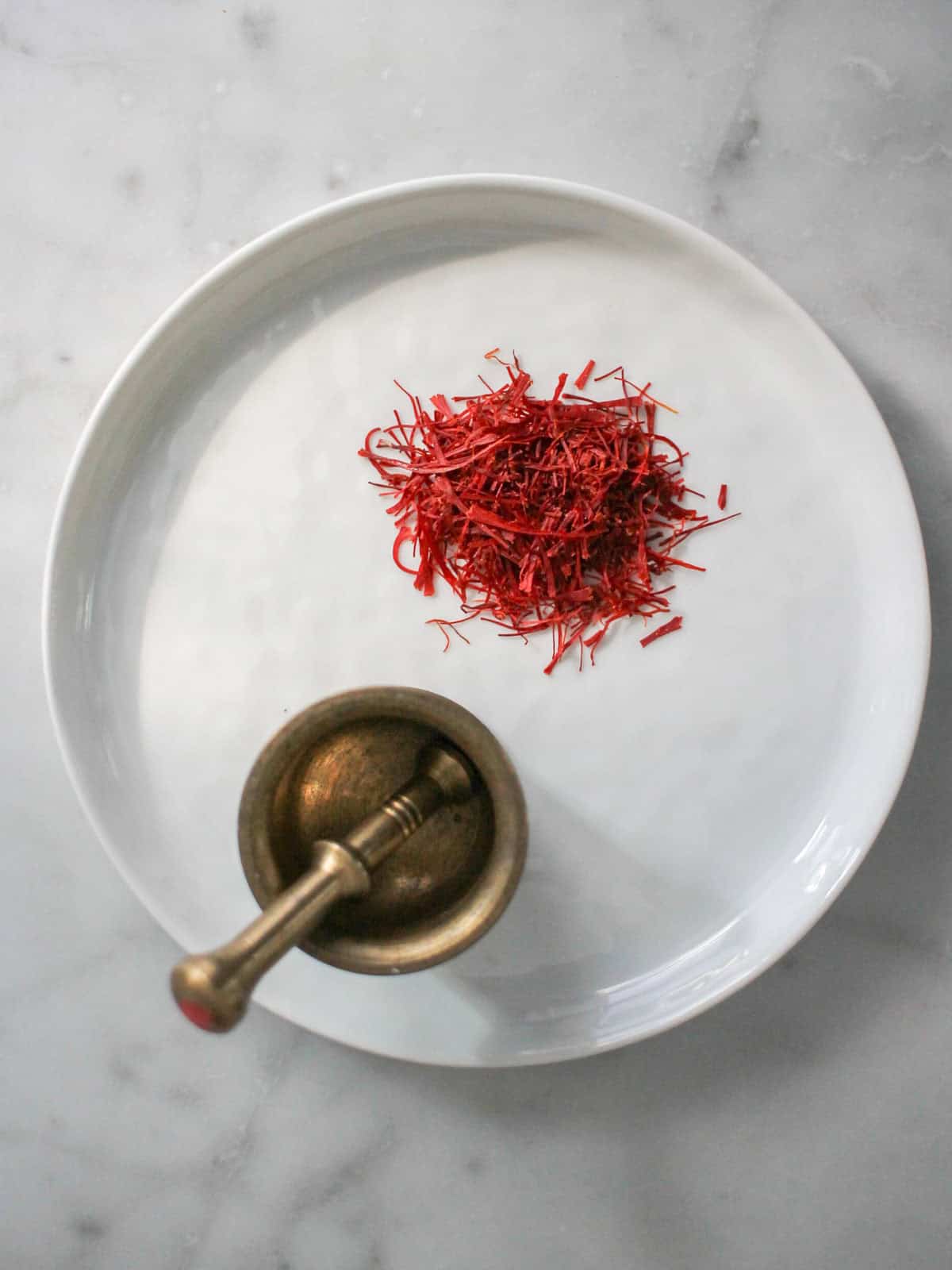 Threads of saffron on a white plate.
