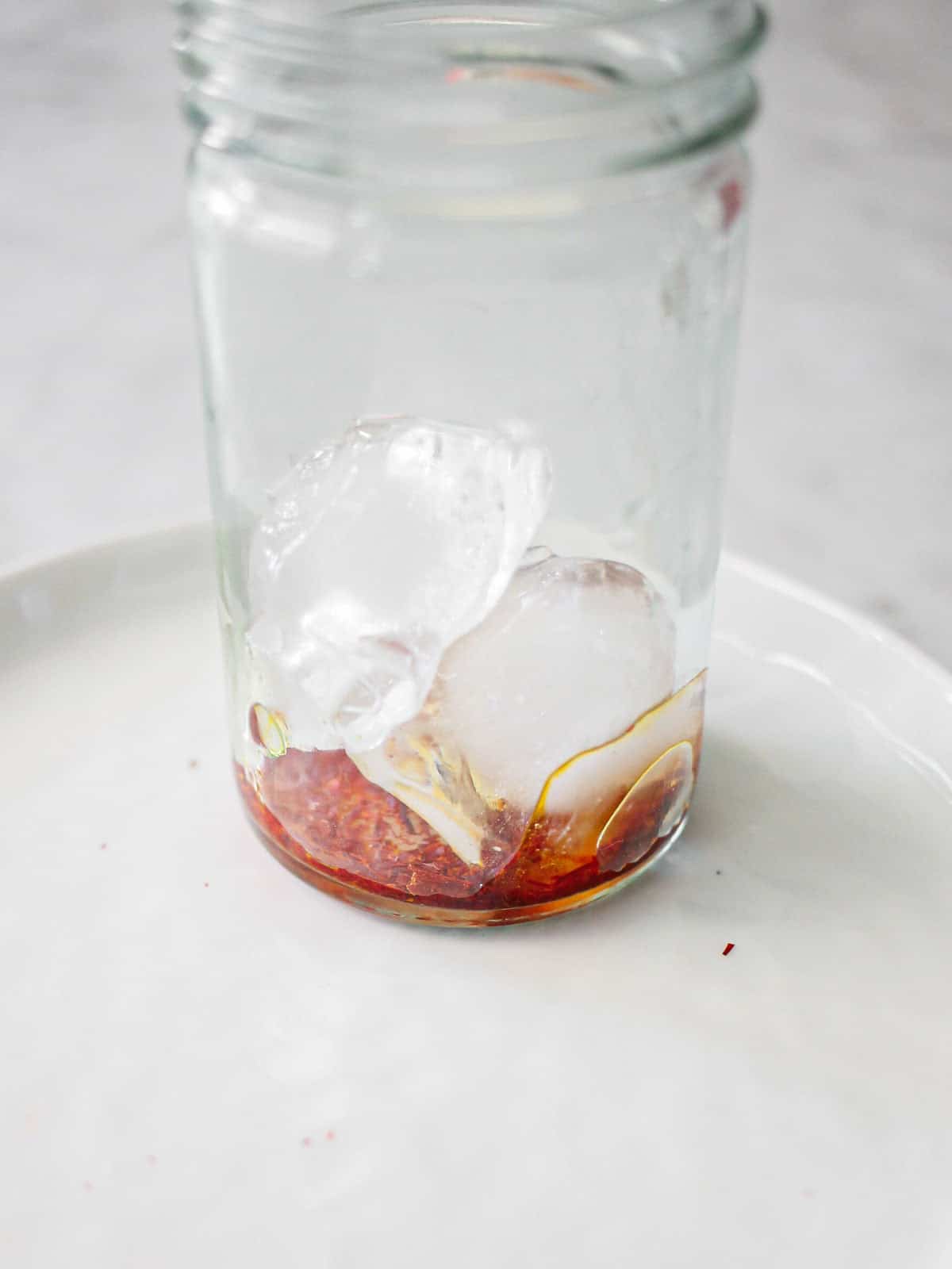 Blooming saffron with ice cubes in a small clear jar.
