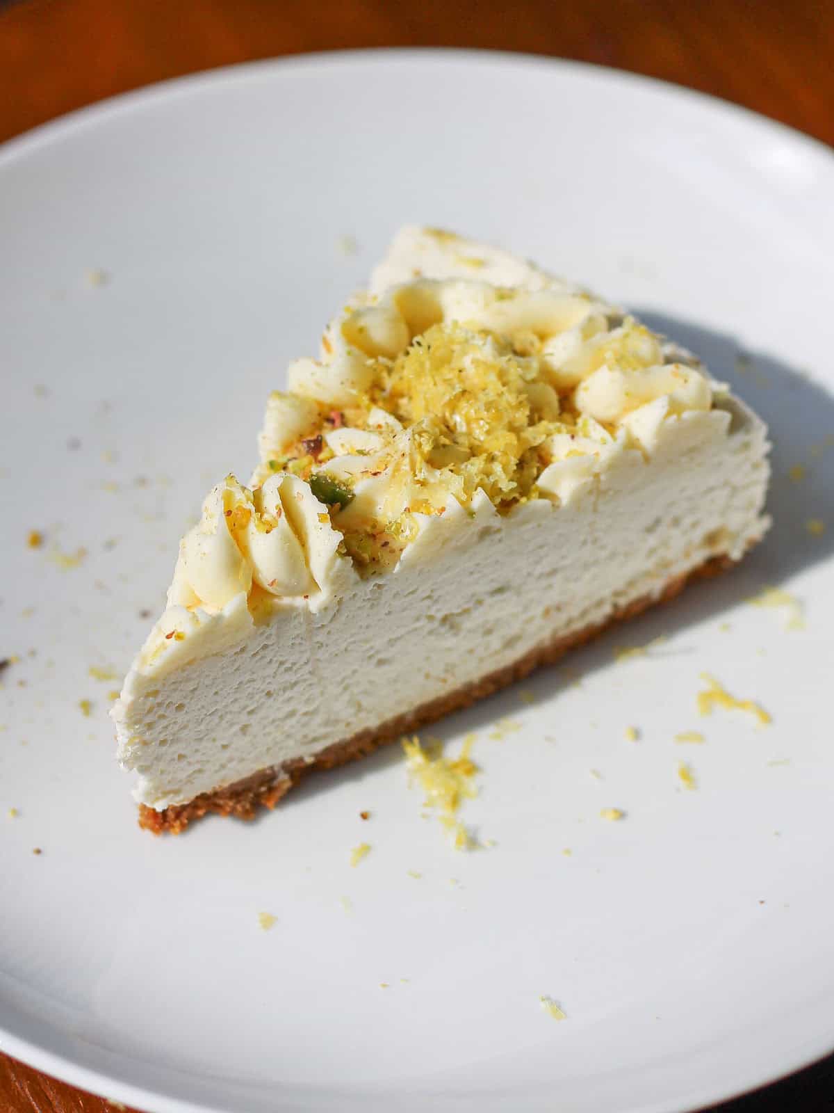 Single slice of cheesecake on a white dessert plate.