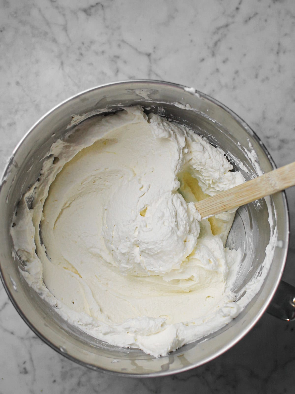 Thick, smooth cheesecake filling after mixing with lemon juice and zest.