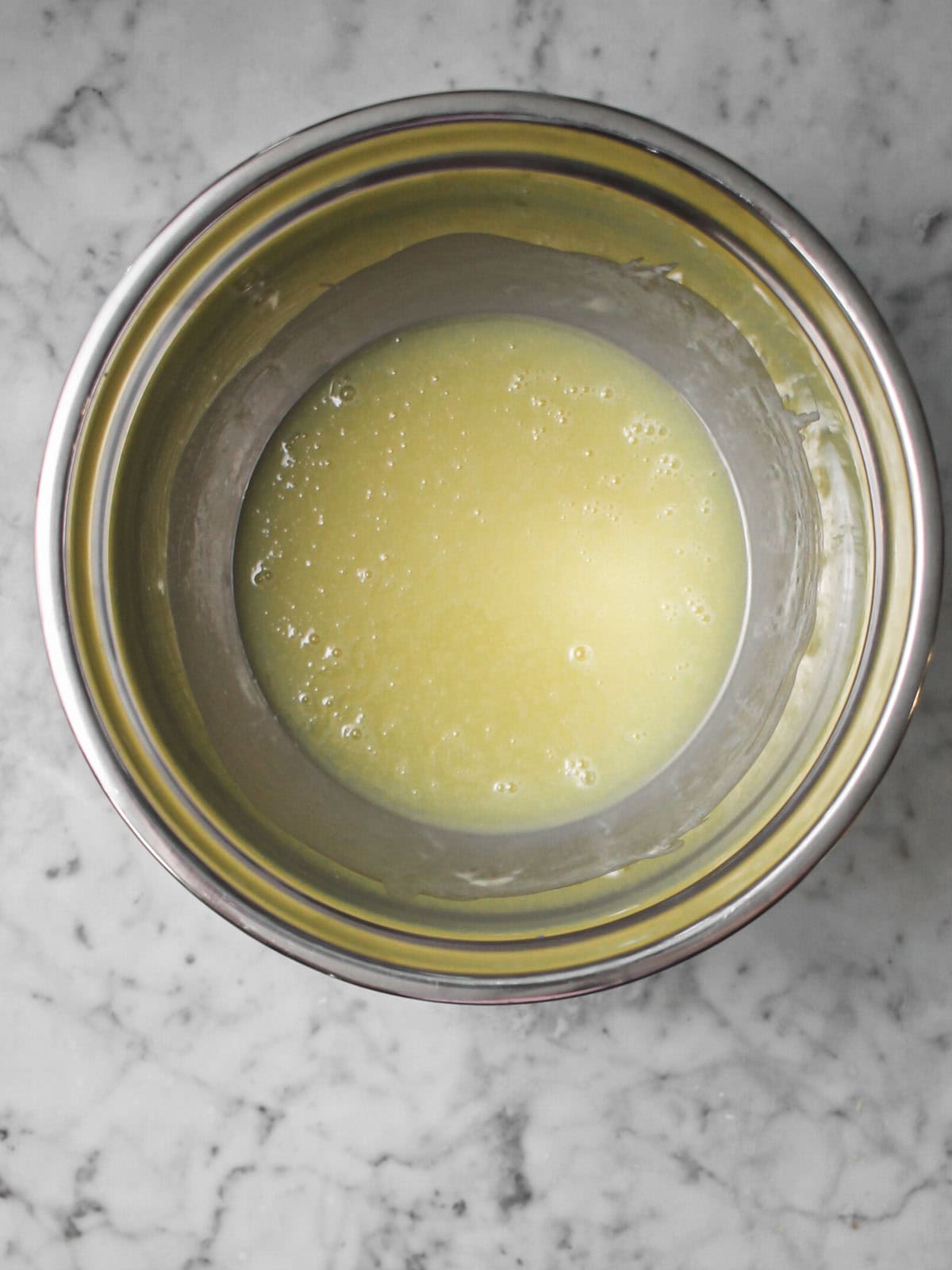 White chocolate ganache stirred until smooth and glossy.