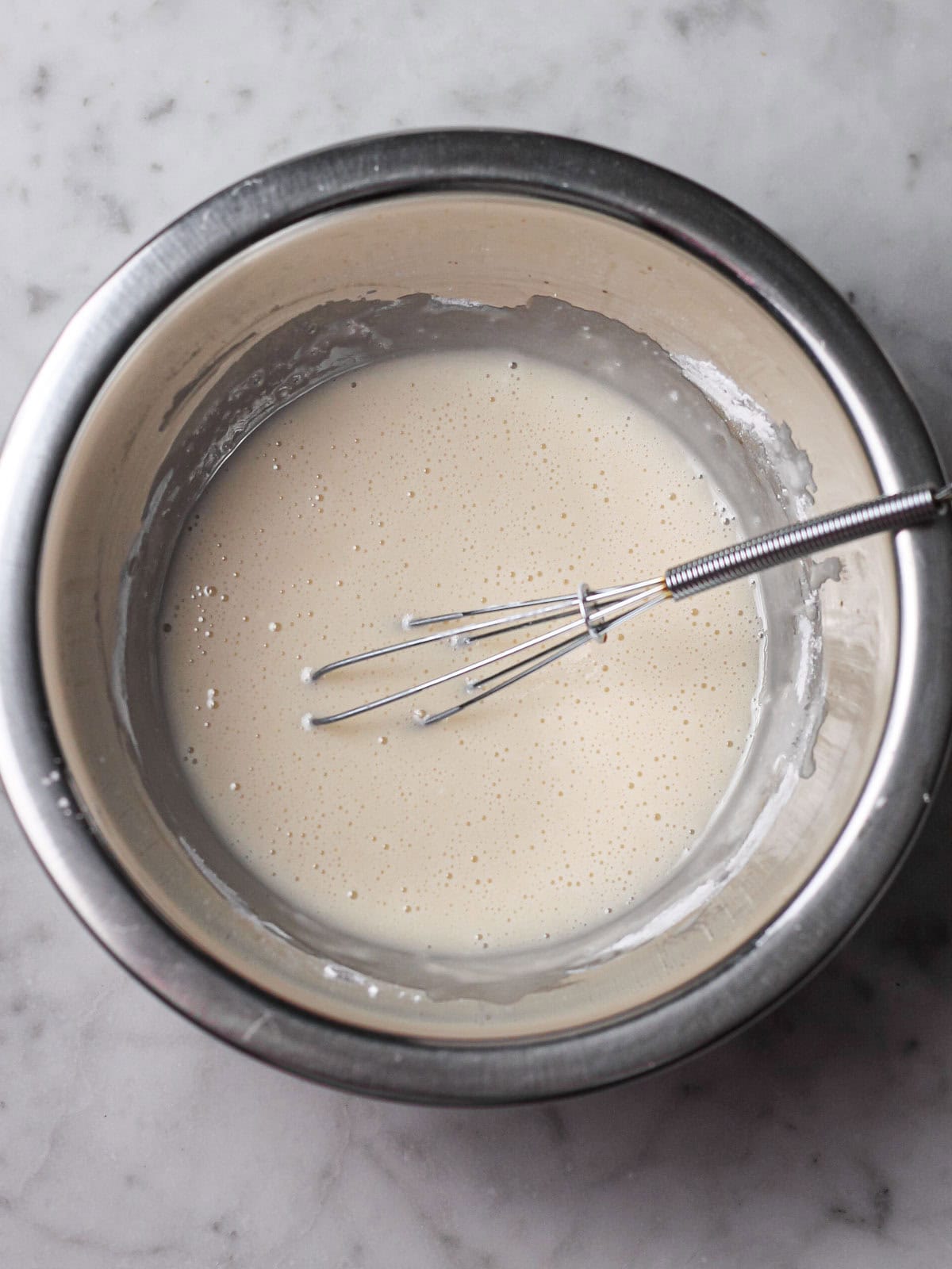 Bowl of ingredients fully combined for vanilla glaze.