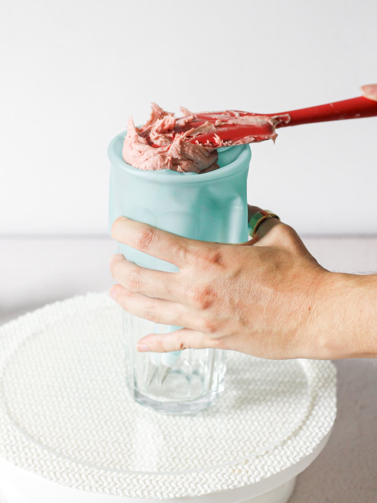 Piping bag folded over a tall cup.
