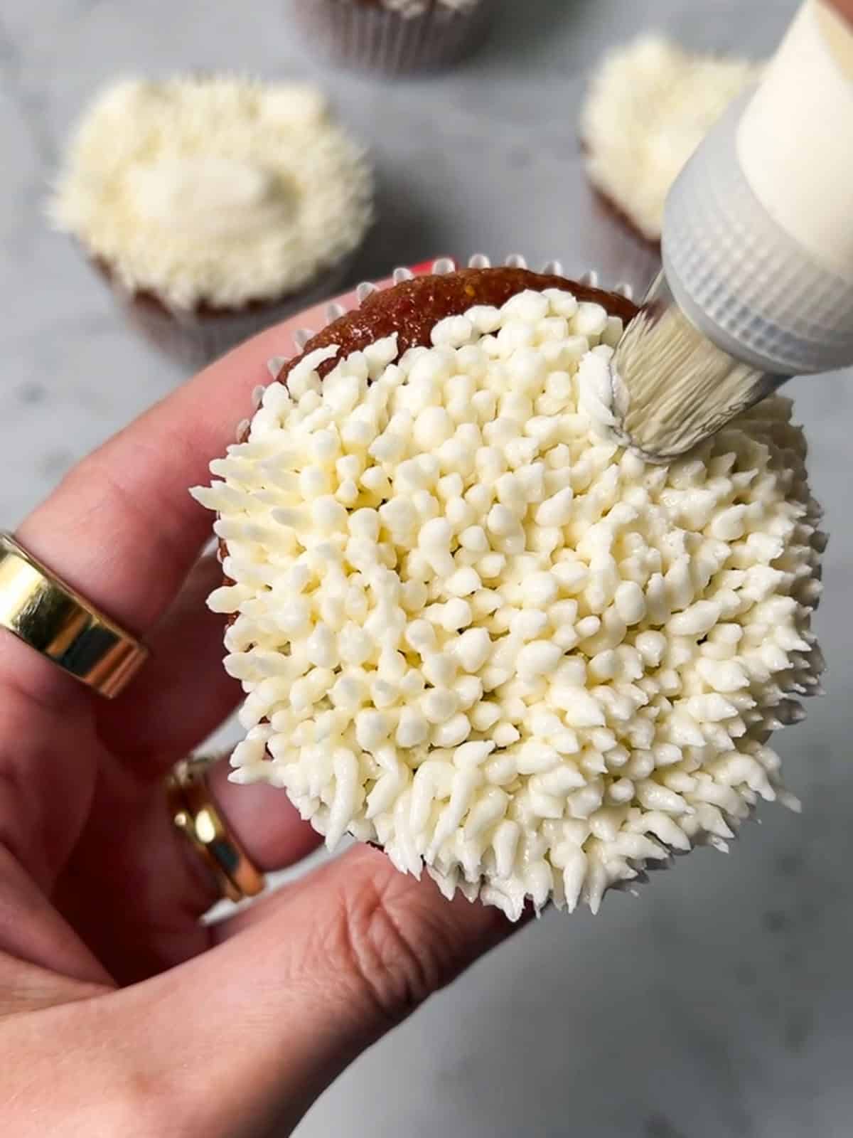 White polar bear cupcake piped in vanilla buttercream.