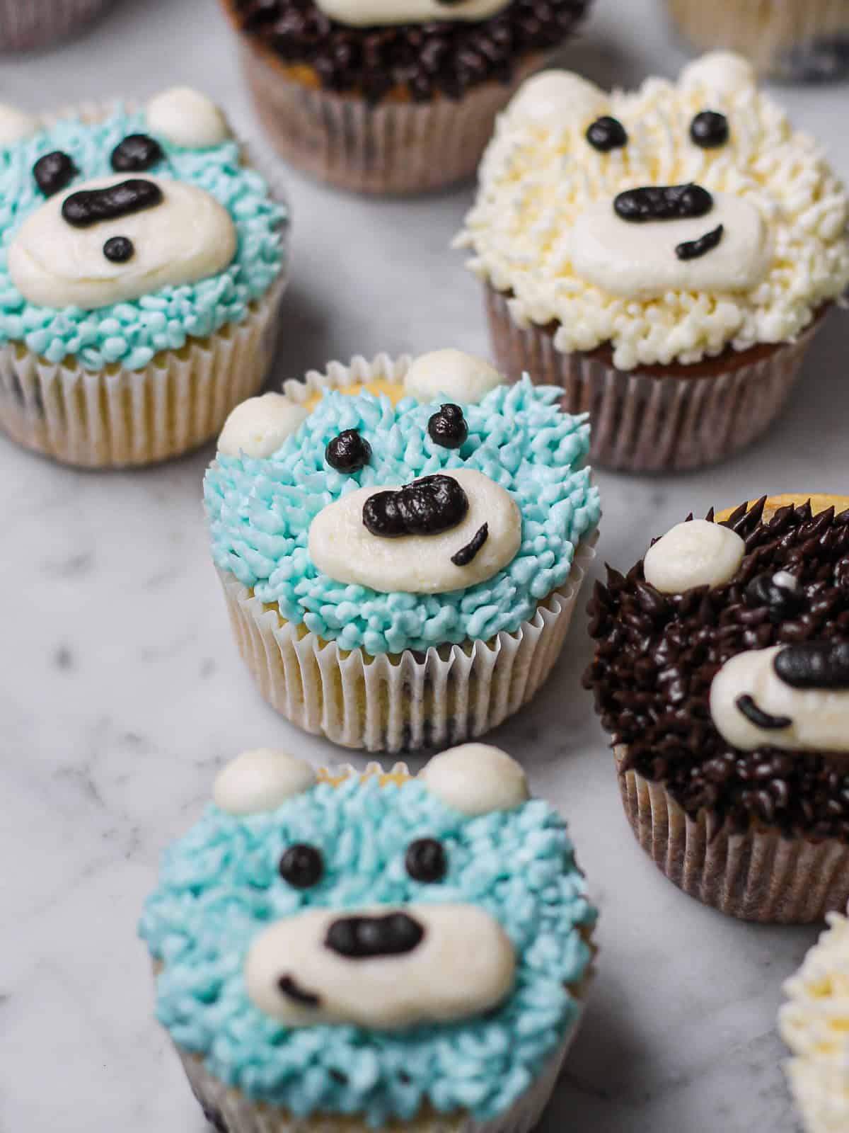 Blue and white teddy bear cupcakes for a baby shower or birthday.