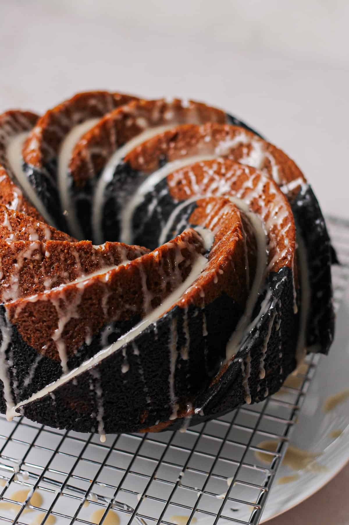 Vanilla glaze drizzled over the cooled marbled Bundt cake.