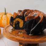 Hero image of the pumpkin bundt cake, with a portion cut to reveal the marbling.