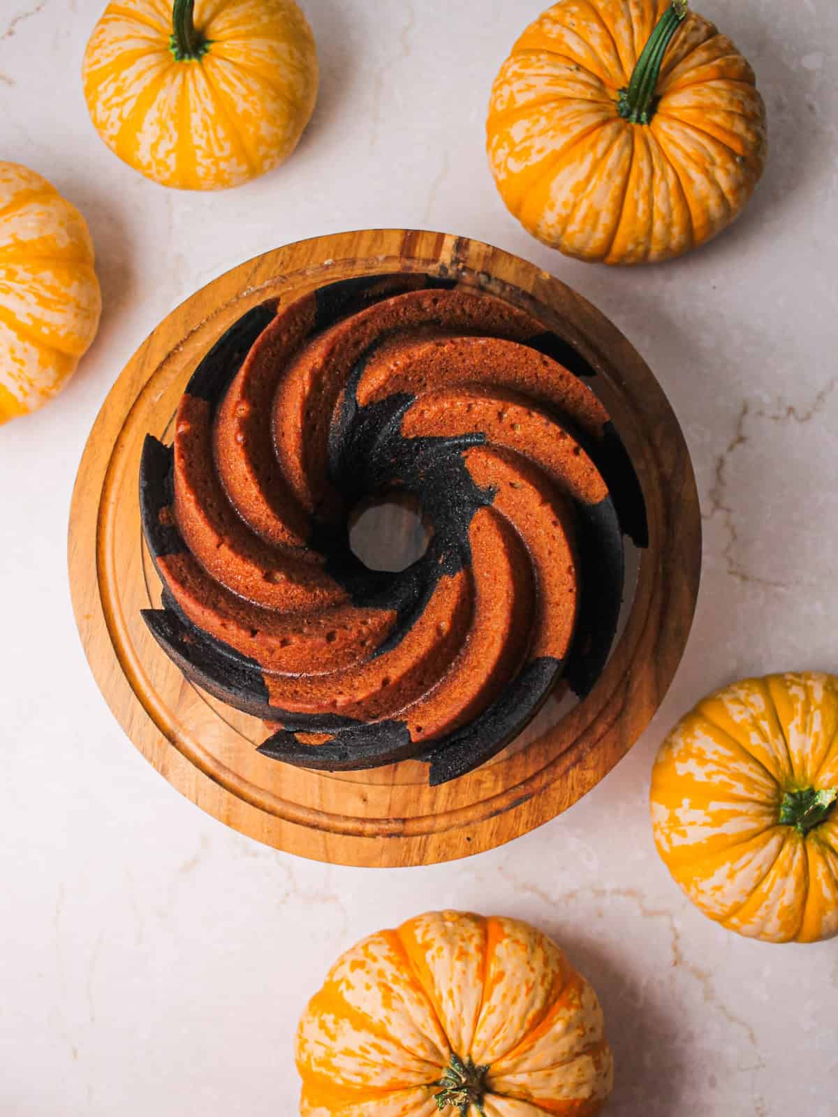 Overhead angle of the orange and black swirled Bundt cake.